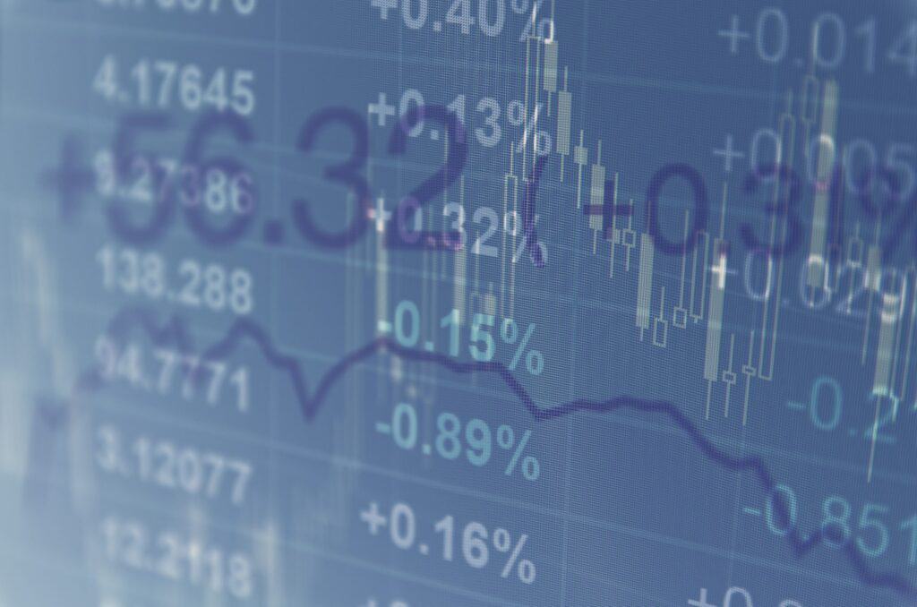 Close-up computer monitor with trading software. Multiple exposure photography.